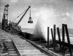 August-1930.-Waves-crash-against-the-seafront-where-construction-of-the-new-promenade-is-under-way.